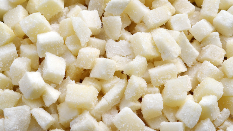 A close-up shot of frozen hash brown cubes