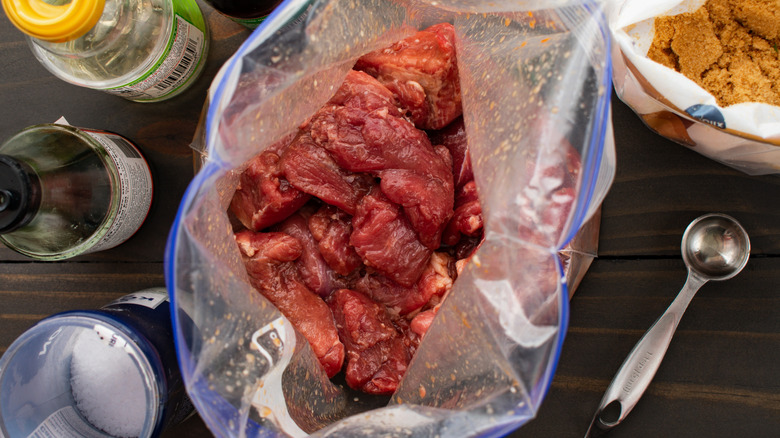 Pork brining in a plastic bag with sauce and spices