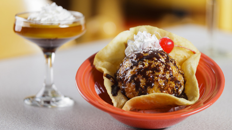 A bowl of fried ice cream and a glass of flan