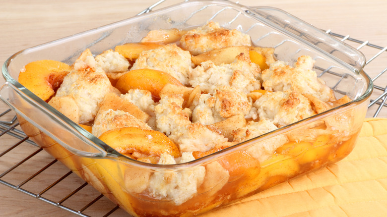 Peach cobbler dessert in a baking dish.