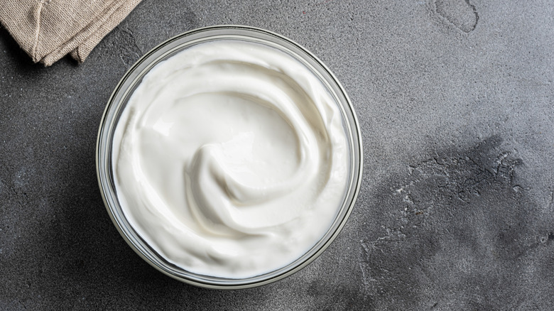 A bowl of Greek yogurt against a gray background