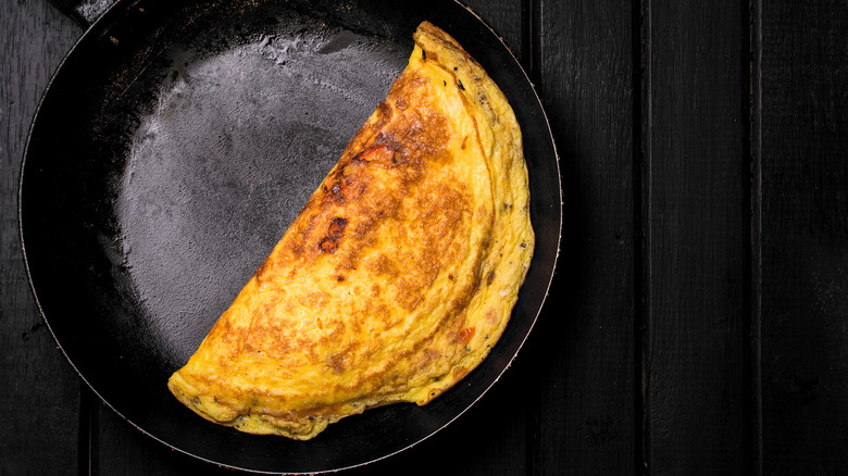 A cooked omelet in a pan.