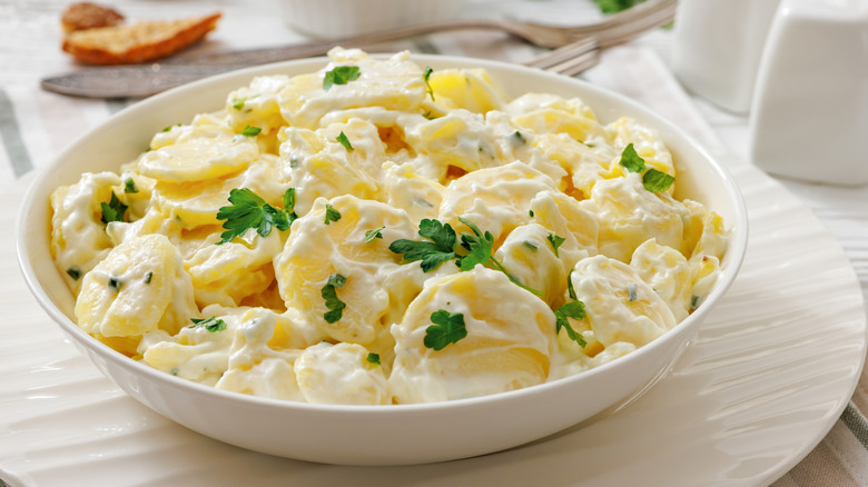 creamy potato salad garnished with herbs