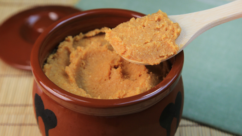 Spoonful of miso paste over a pot
