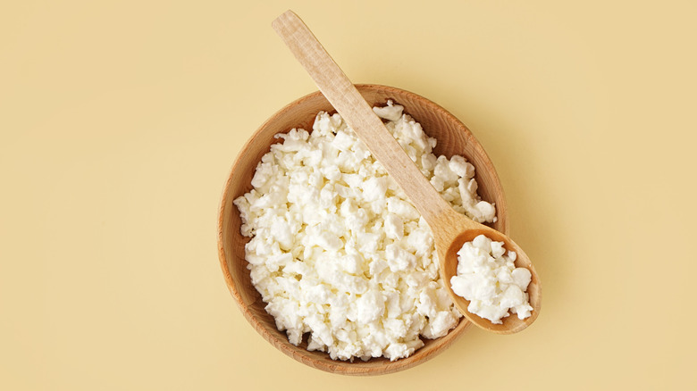 A bowl of cottage cheese with a spoon