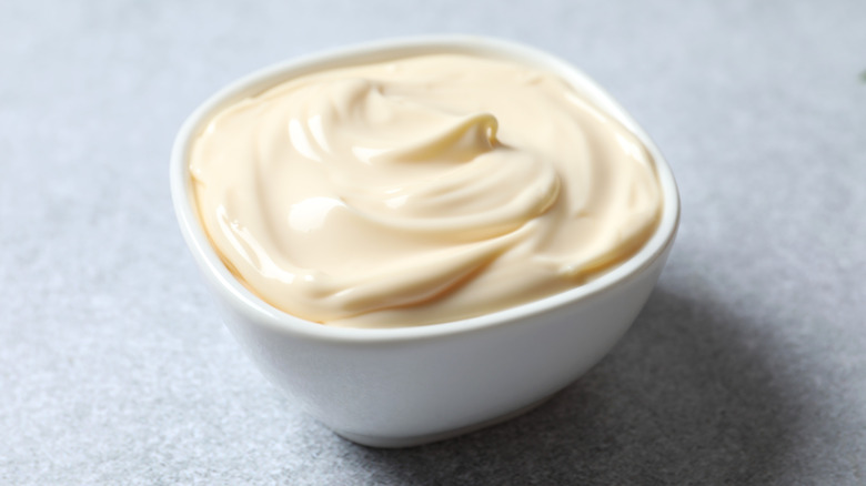 White bowl of mayonnaise.