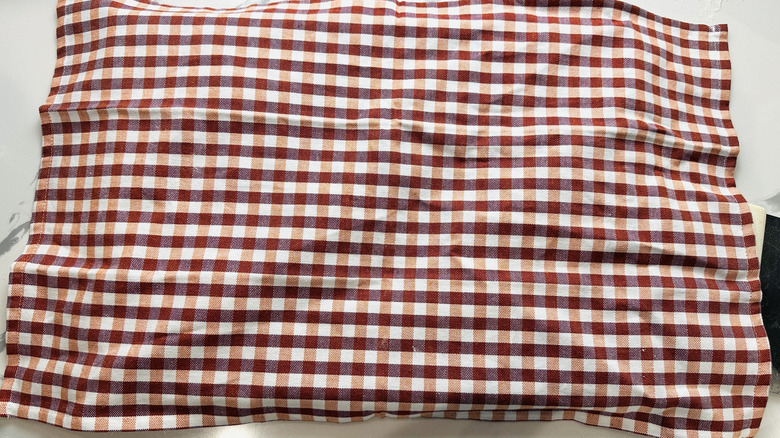 red checked napkin covering a pan