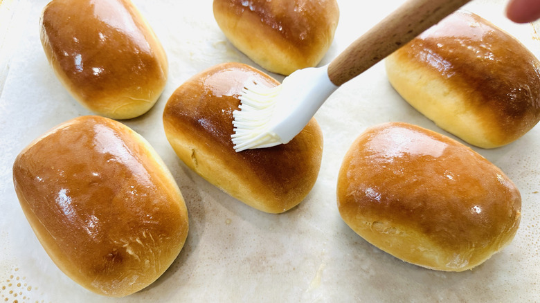 brush touching the top of a bread roll