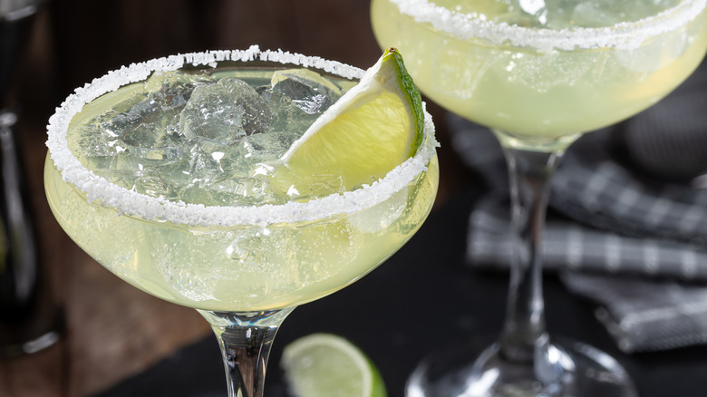 Close up of a margarita with ice and lime wedge