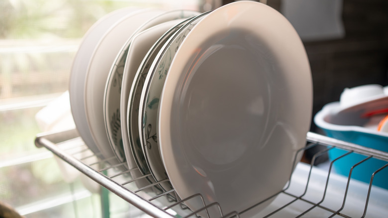 Plates on a dish drying rack in the kitchen