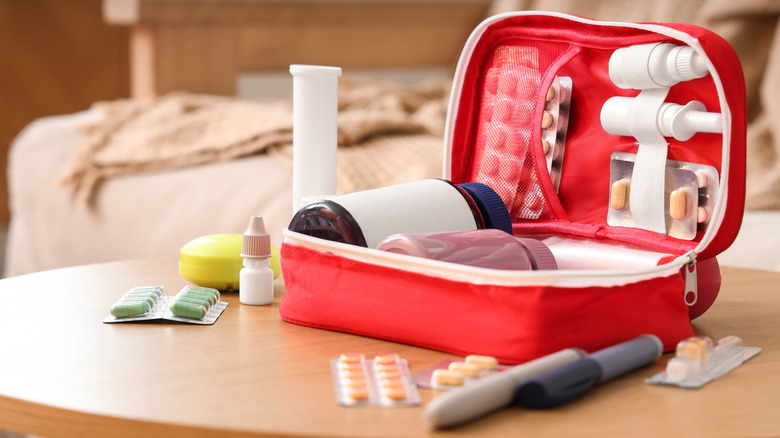 first aid kit with medical supplies on a table