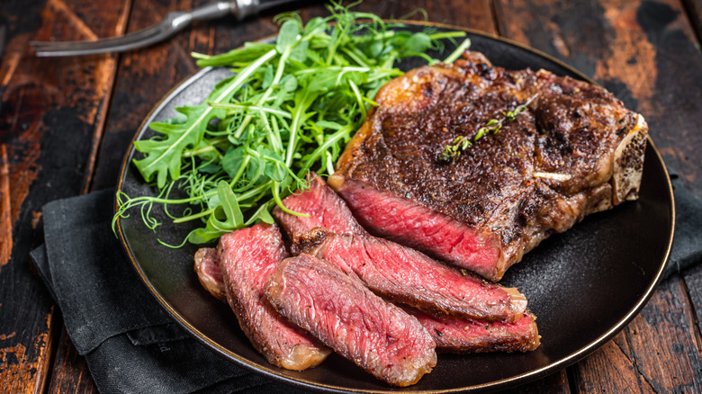 Kobe beef and salad greens on a plate