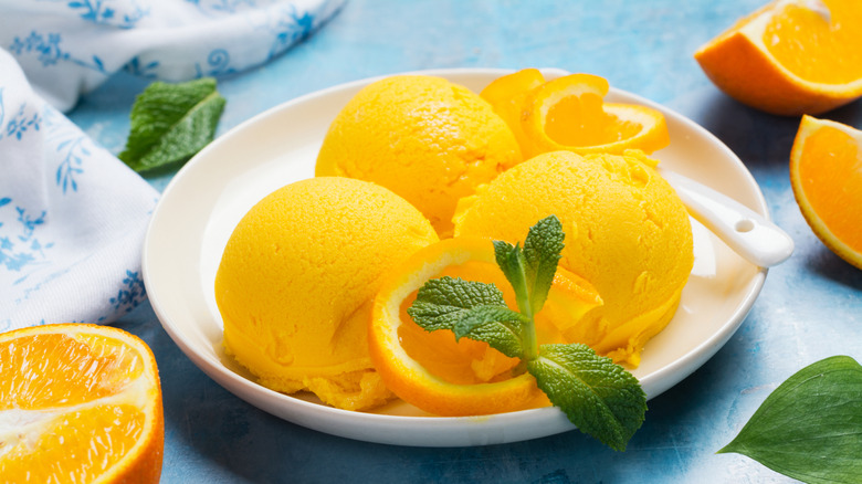 scoops of orange sherbet garnished with mint