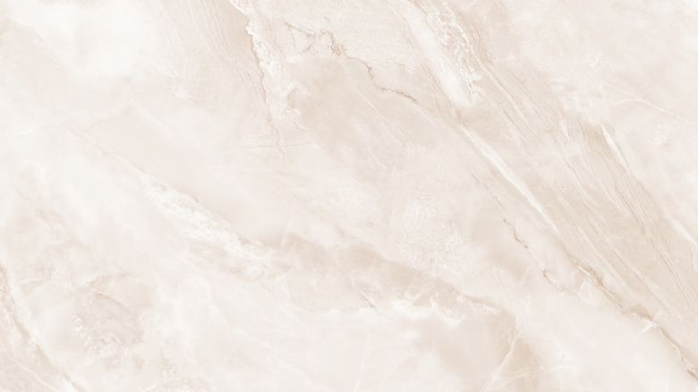 A close up of a light pink marble slab
