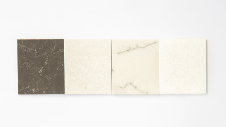 A selection of marble tiles in different color variations on a white background