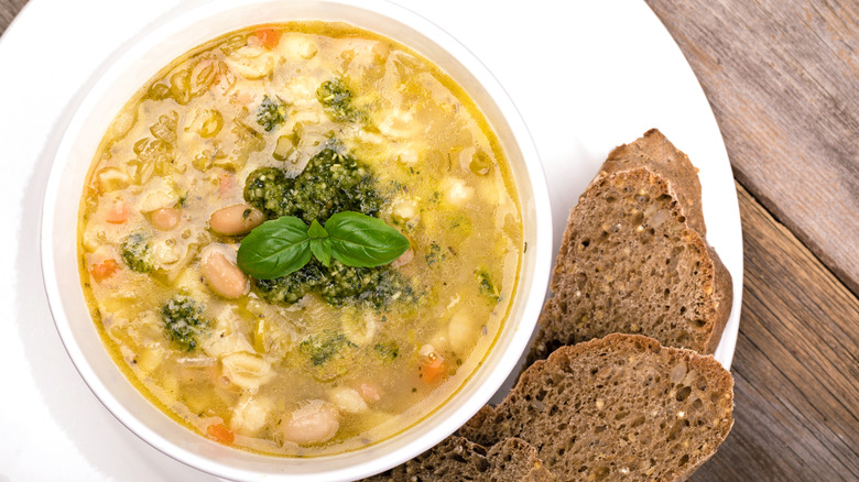 A white bean soup accompanied by bread on the side.