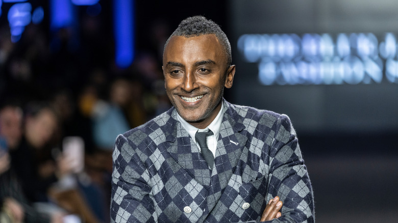 Marcus Samuelsson smiling, wearing a tie and jacket.