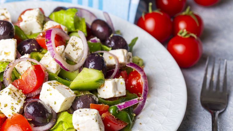 A greek salad is served on a plate