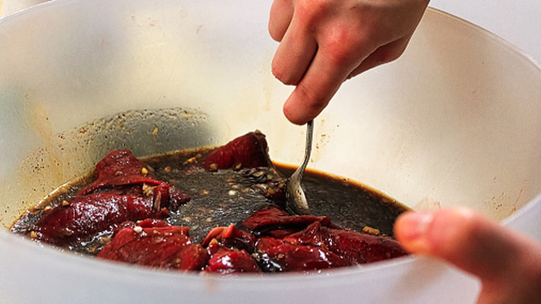 A cook preparing a marinade.
