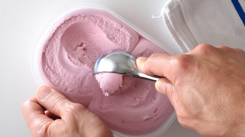 person scooping out ice cream