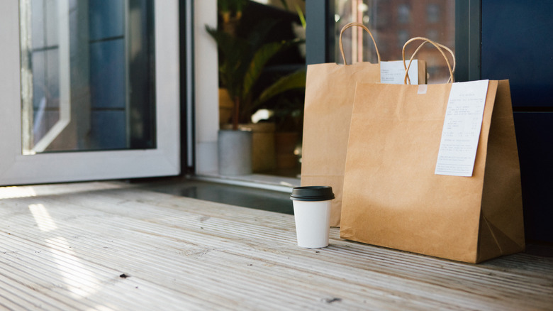A food delivery appears on a front porch.