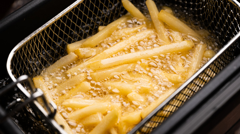 frying potatos in fryier for french fries