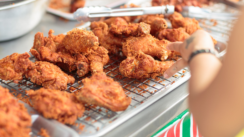 Several pieces of fried chicken on a wire rack.