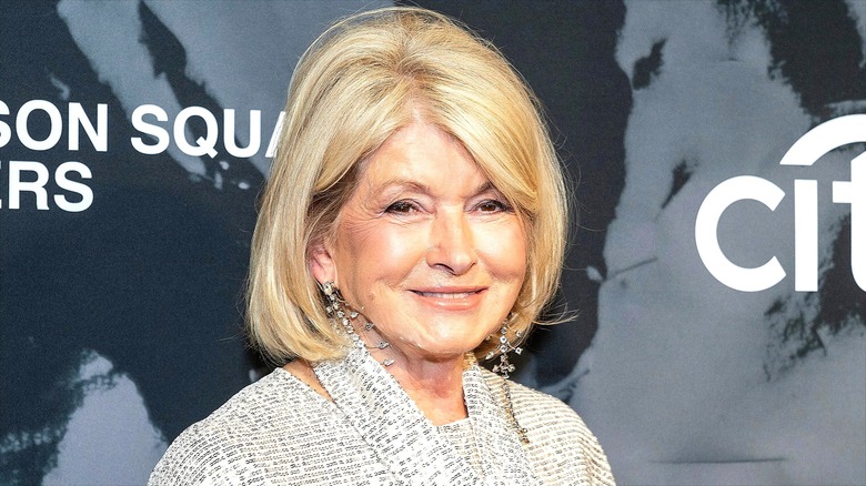 Martha Stewart smiling while wearing long gemstone earrings