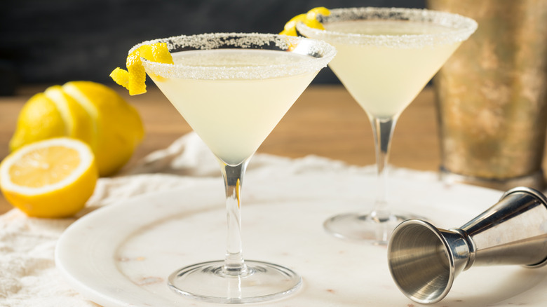 Two lemon drop cocktails with a sugar rim on a plate