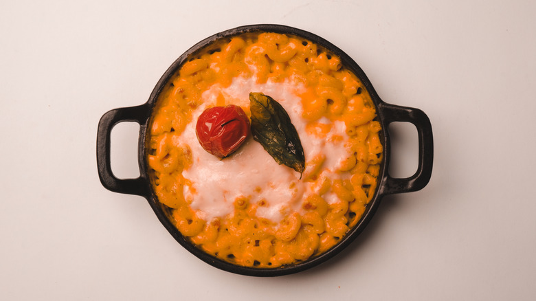 Mac and cheese garnished with a roasted cherry tomato