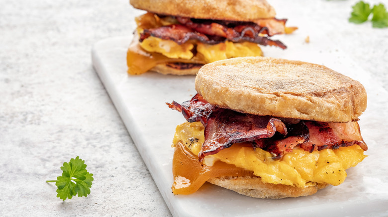 Two bacon, egg, and cheese sandwiches on an English muffin.