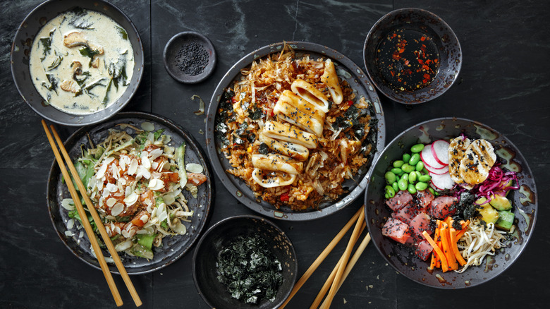 A mix of Japanese style dishes on a stone surface