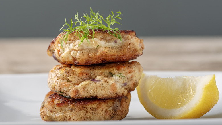 Salmon cakes with garnish and a lemon wedge