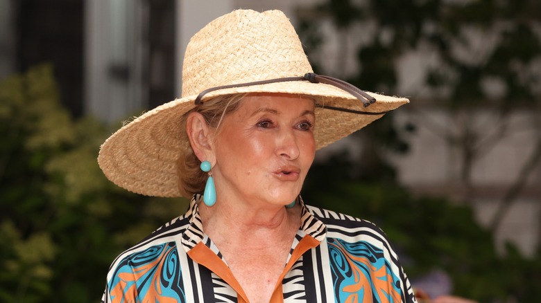 Martha Stewart wearing a wide-brimmed sun hat