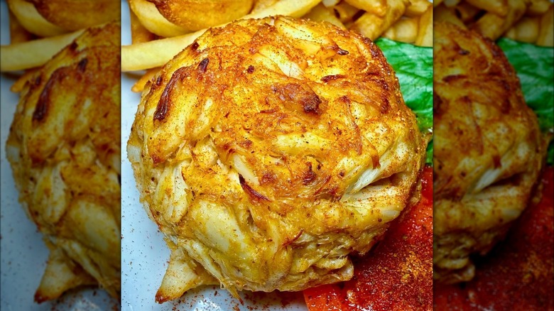 A single Koco's crab cake on a plate with fries and salad