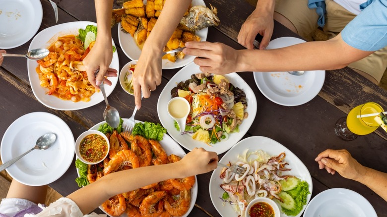 Overhead view of people eating at a seafood restaurant table