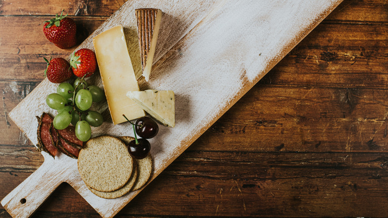 A simple cheese and charcuterie board can easily be scaled down to fit into a Mason jar for transport.