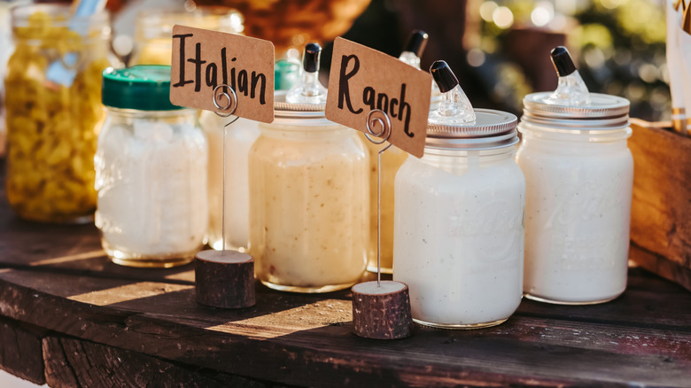 Mason jar containers holding dressing