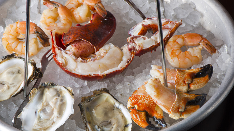 A shellfish tower tier with shrimp and other items