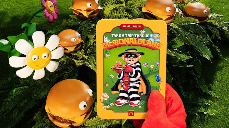 A hand holding a collectible Hamburglar tin from McDonald's