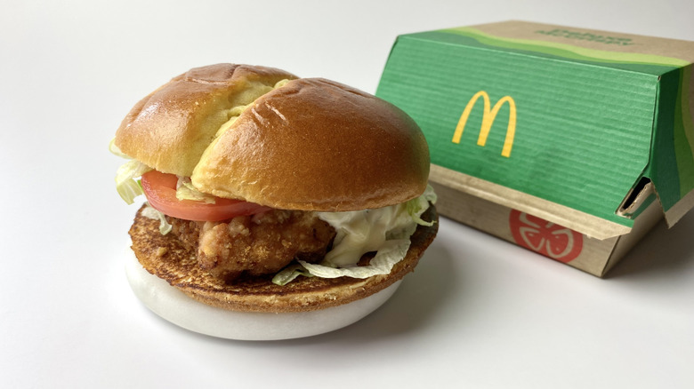 McDonald's Deluxe McCrispy sandwich with its packaging behind it