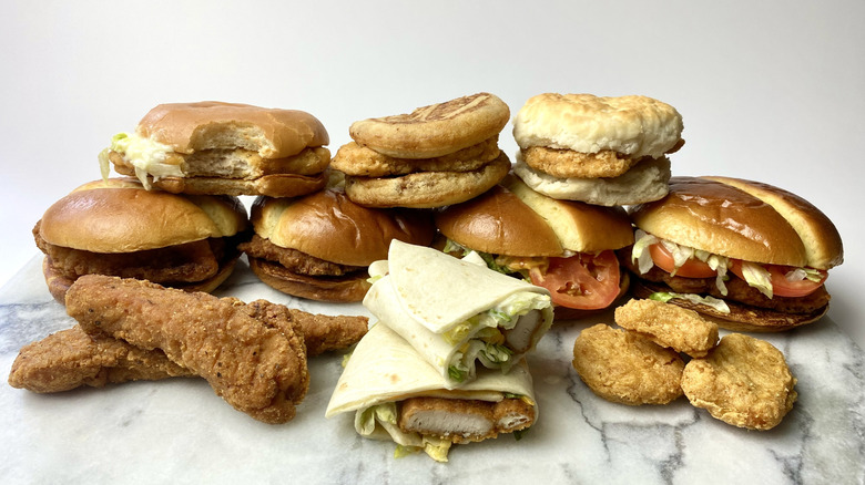 Rows of McDonald's chicken items on a marble board next to their packaging