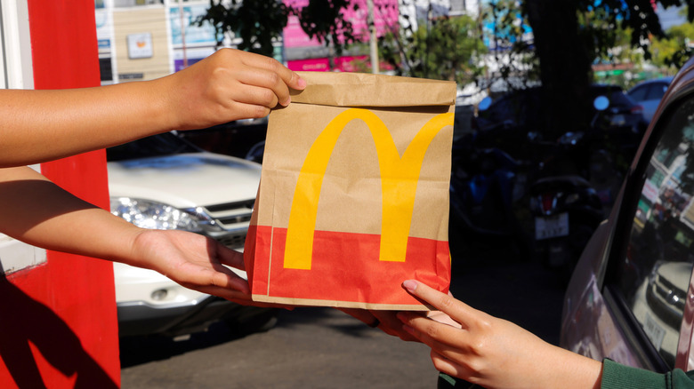 McDonald's bag being handed to drive-thru driver