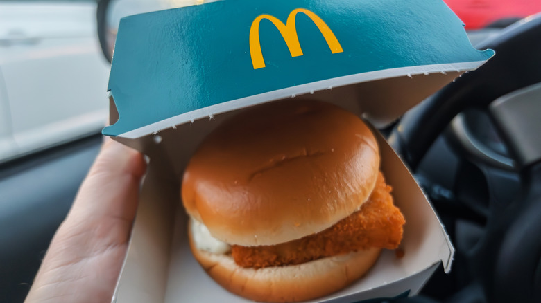 hand holding a box of McDonald's Filet-O-Fish