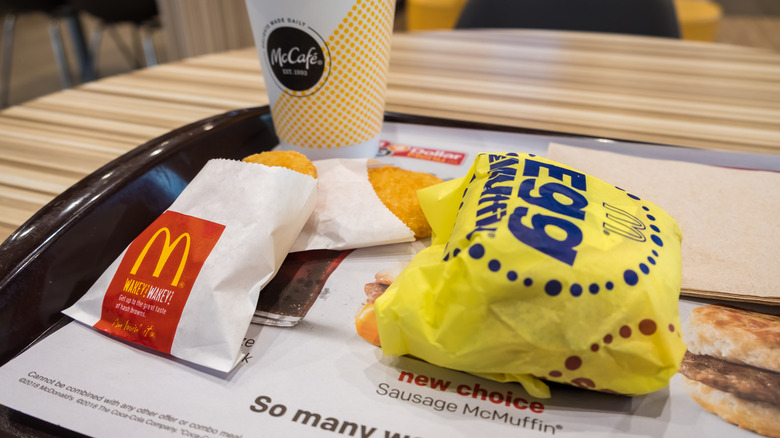 McDonald's Egg McMuffin, hash brown, and drink on a tray