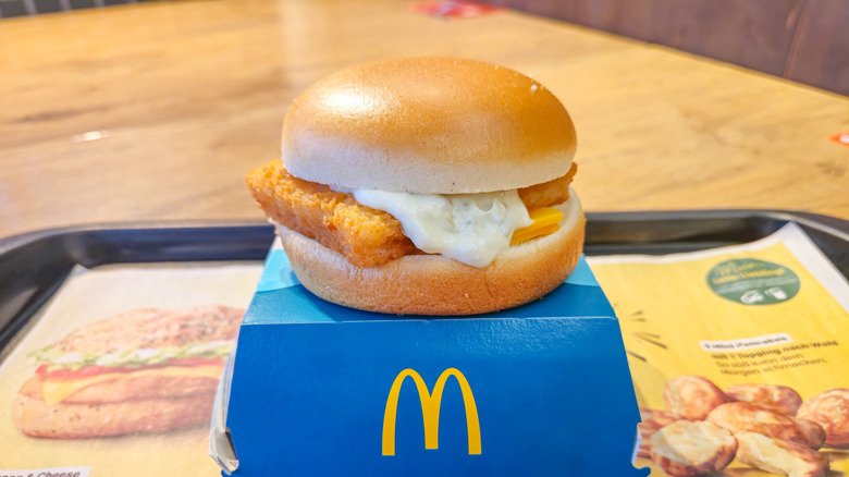 A filet-o-fish sandwich on a blue McDonald's box