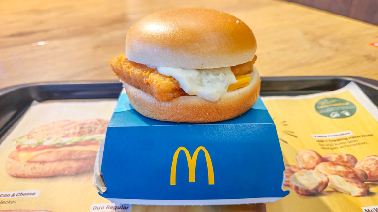 A Filet-O-Fish sitting atop its package at McDonald's