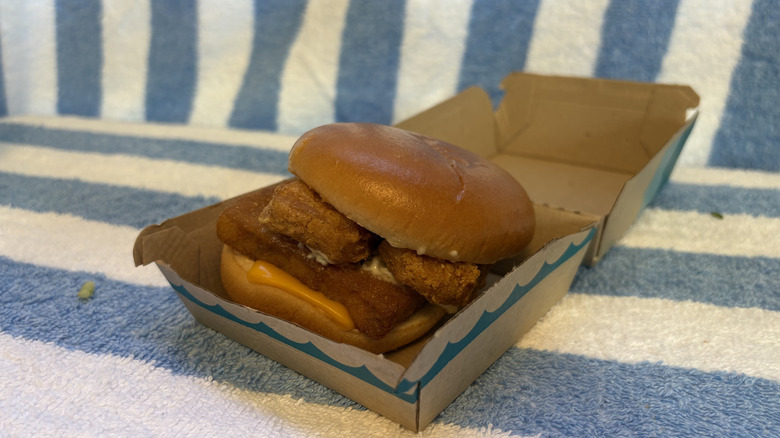 A Filet-O-Fish sandwich with chicken McNuggets inside of it