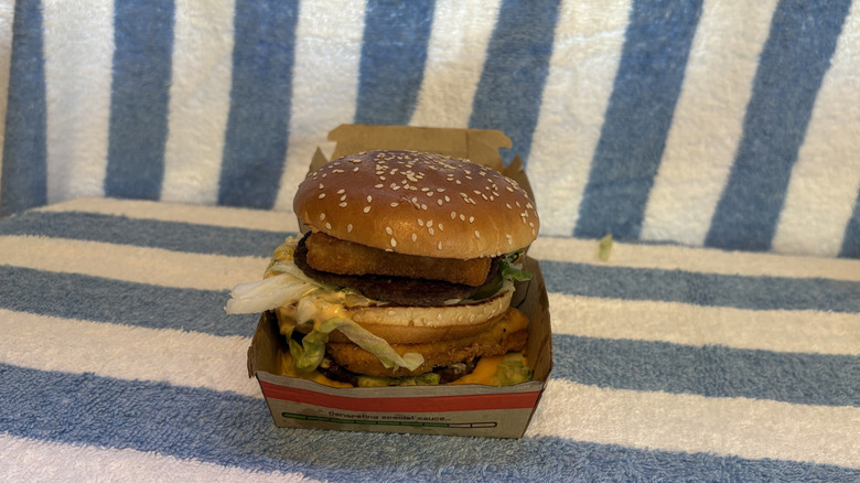 A Big Mac from McDonald's with a fish filet and chicken patty stuffed inside