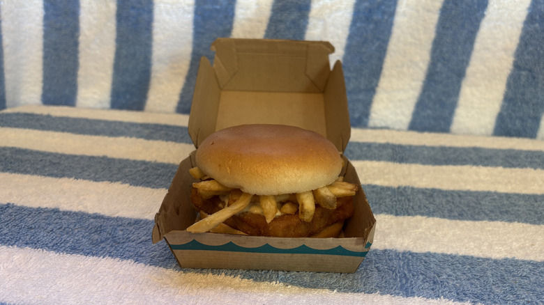 A Filet-O-Fish sandwich with fries in it, in its box